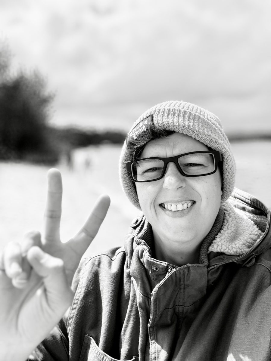 Founder at the beach, peace sign, big smile
