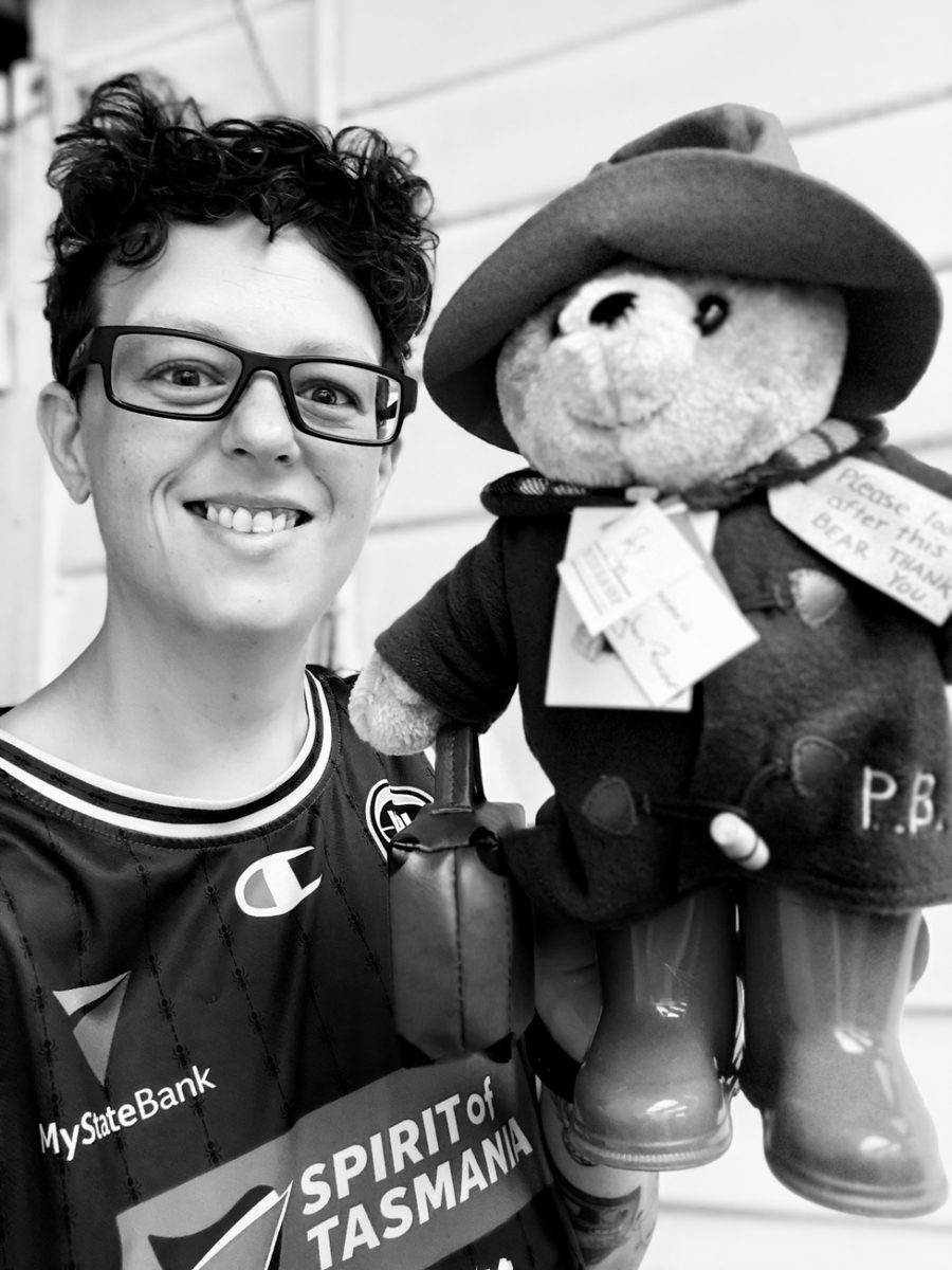 Holding a Paddington Bear toy wearing Spirit of Tasmania jersey