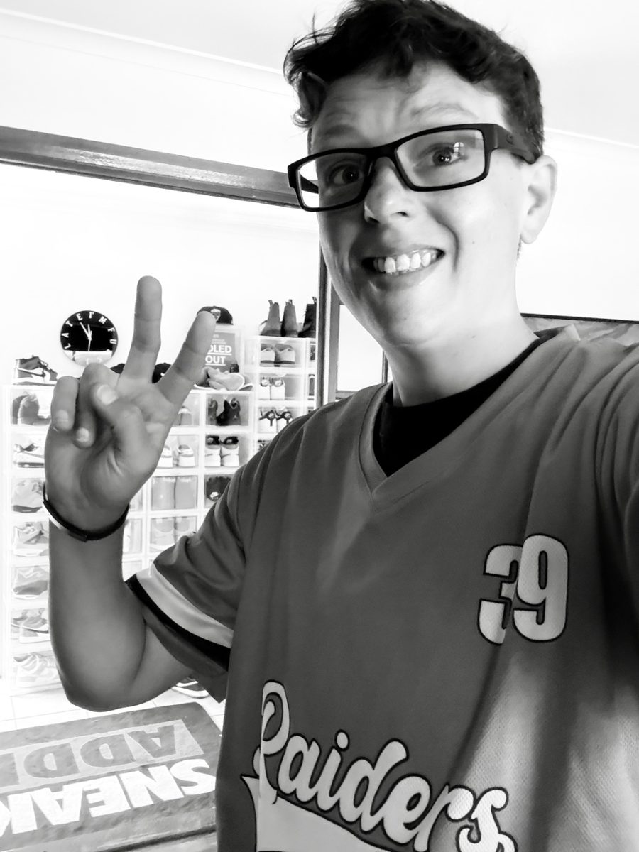 Peace sign in front of a sneaker collection wall